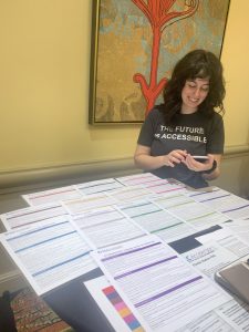 Photo of Torie Wynn, overseeing the Field Guide station and our Engagement Map display at the OLC Accelerate 2019 conference in Orlando, FL.