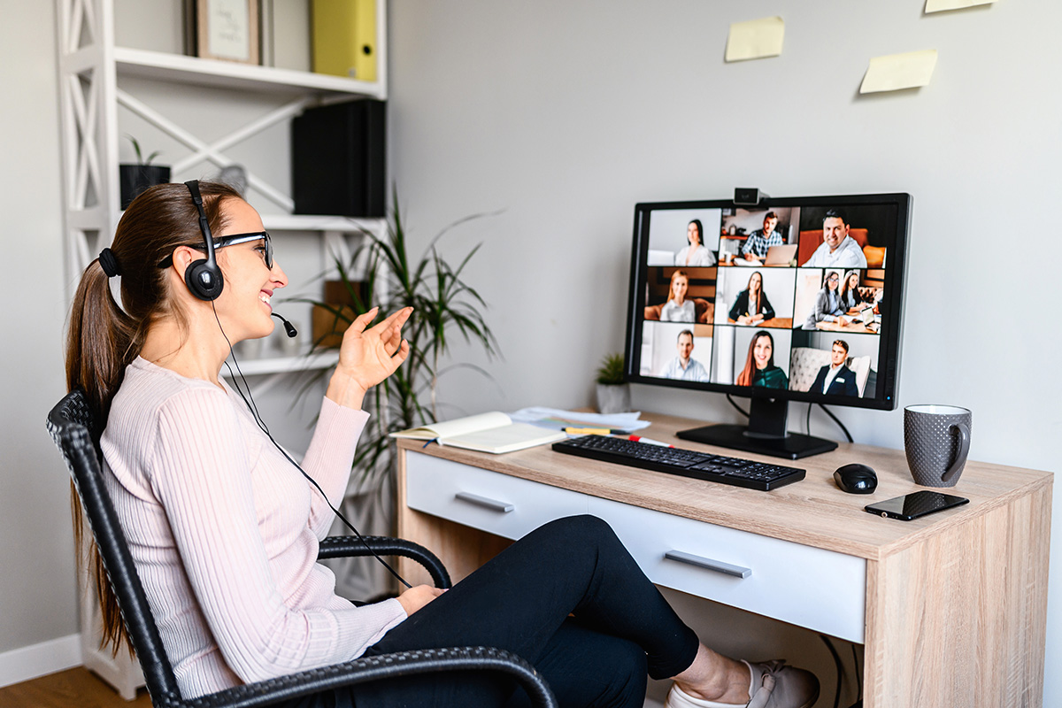 Woman gesturing during video meeting at home office